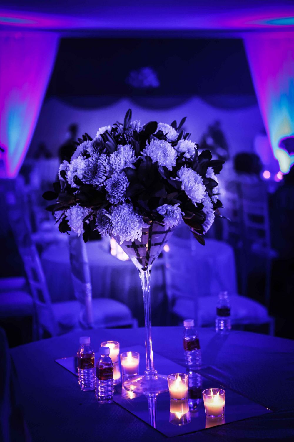 Photo of Table setting with floral centerpiece and candles