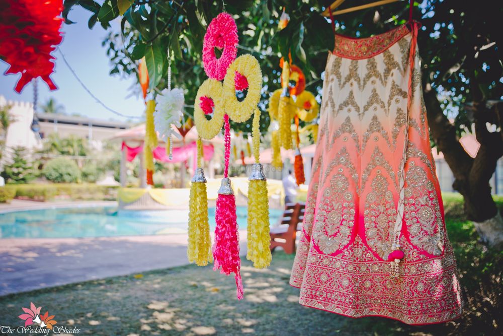 Photo of Orange and pink ombre lehenga on hanger