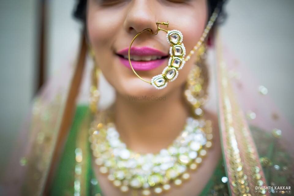 Photo of Green and gold statement bridal nath