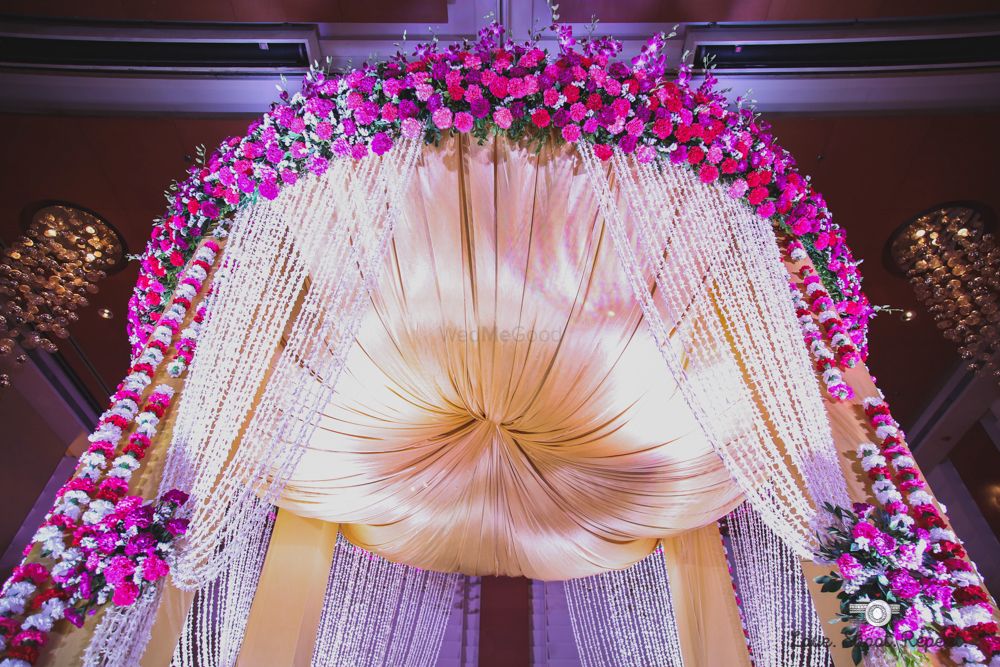 Photo of Gold and pink floral decor mandap
