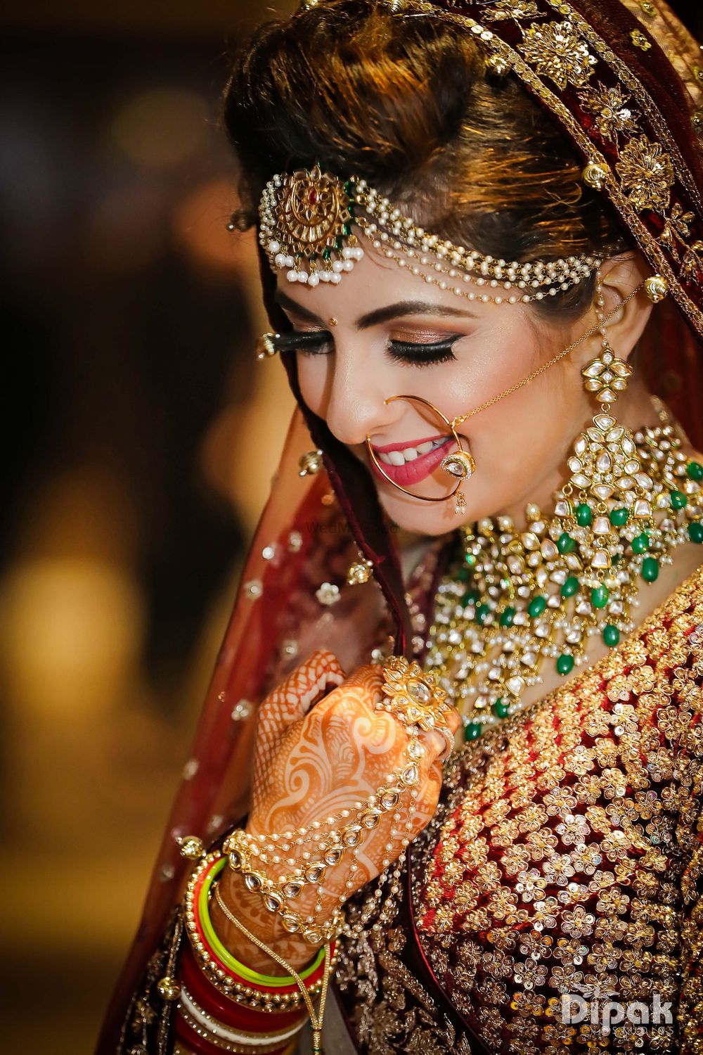 Photo of Bride wearing necklace with green beads and pearl maangtikka
