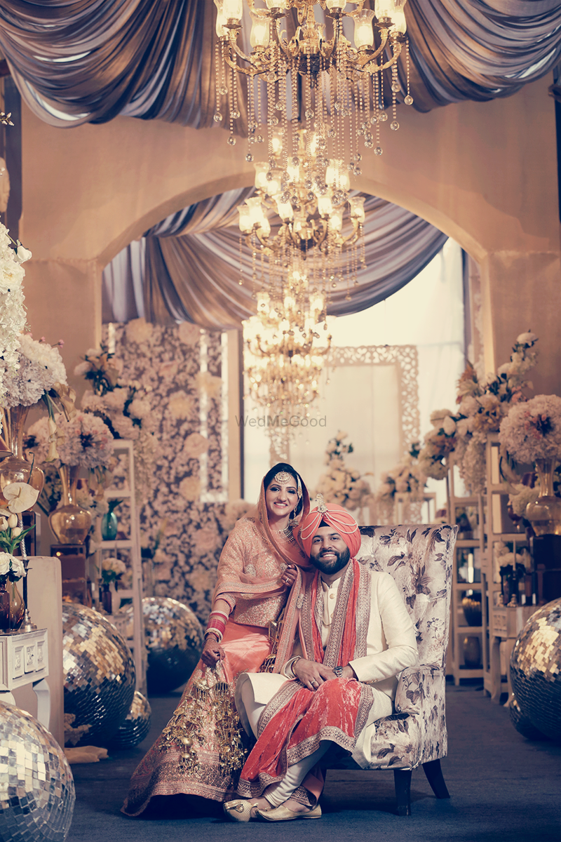 Photo of chandeliers and floral sikh wedding decor