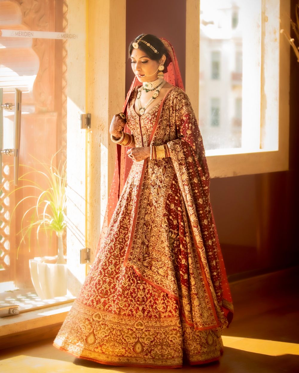 Photo of Bride dressed in a regal bridal lehenga.
