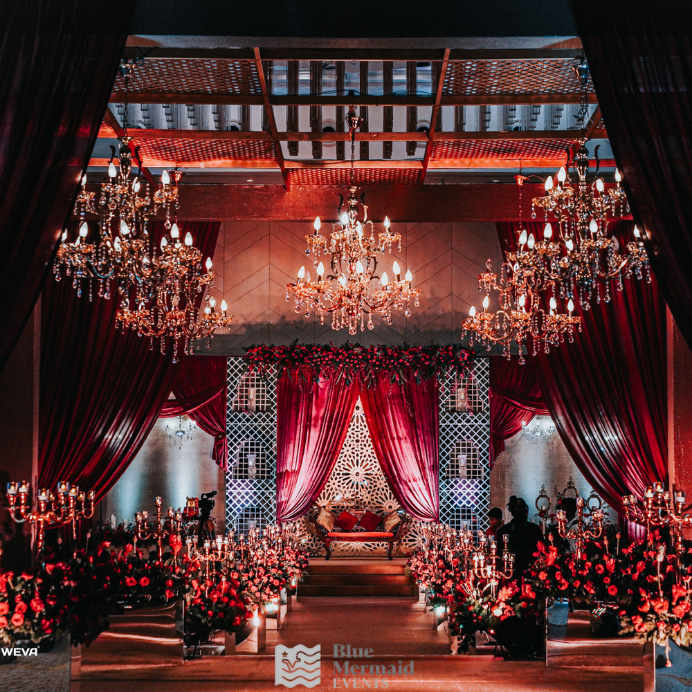 Photo of grand engagement decor with hanging chandeliers