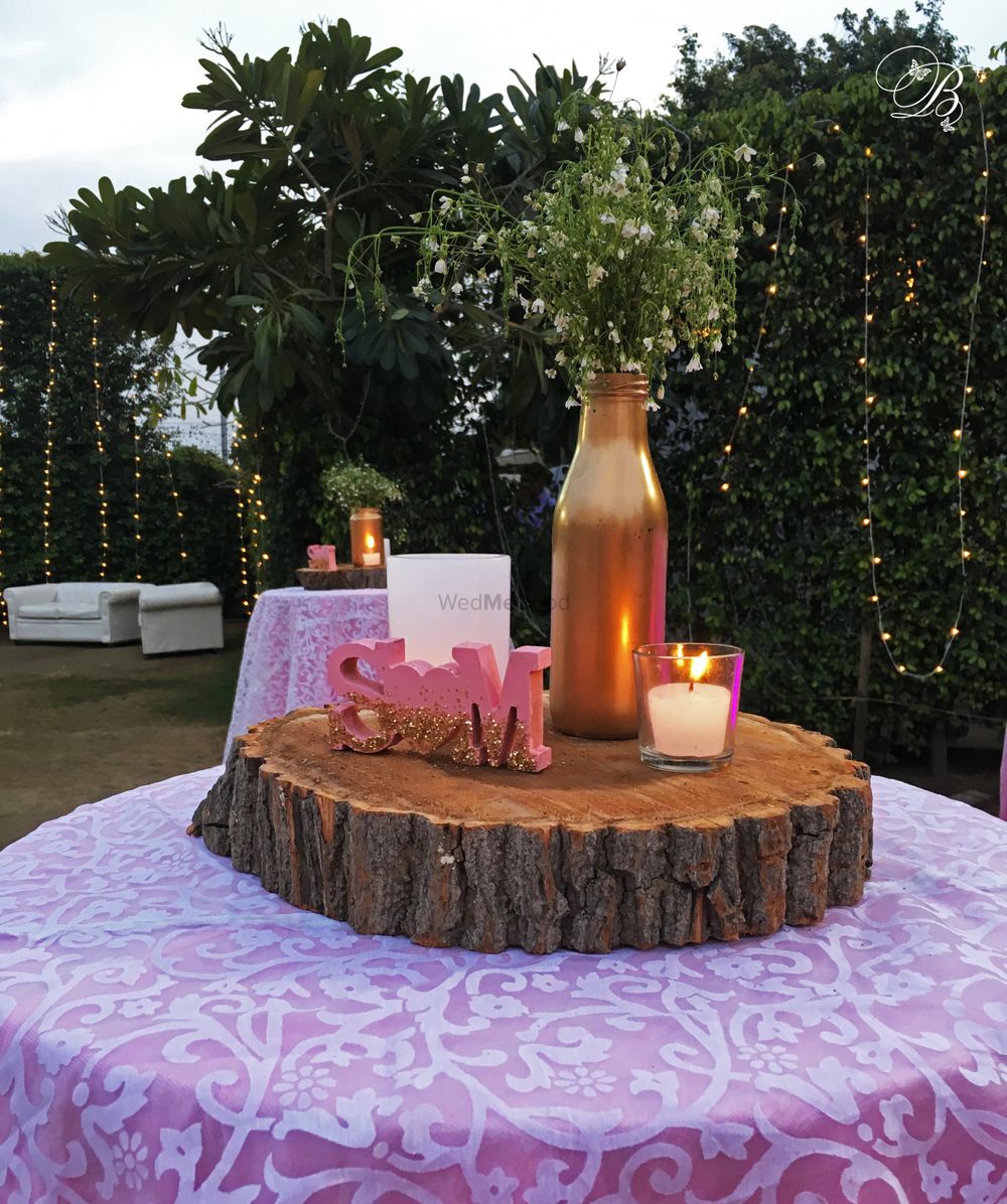 Photo of Unique rustic centerpiece with wooden log and couple initials