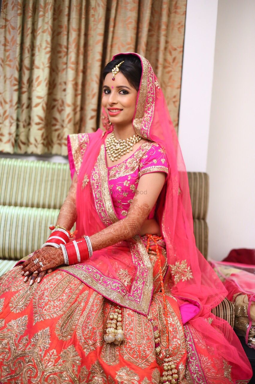 Photo of orange and pink bridal lehenga