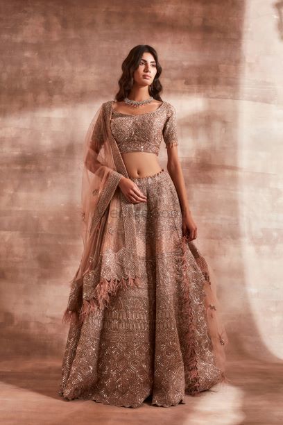 Photo of Stunning peach lehenga with silver work and dupatta with tassels