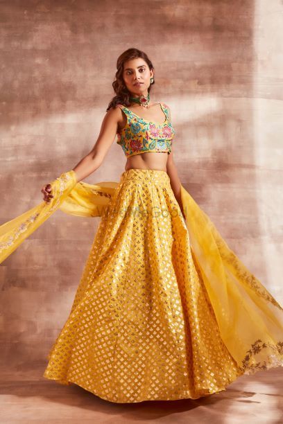 Photo of Yellow lehenga with embroidered turquoise blouse perfect for Haldi