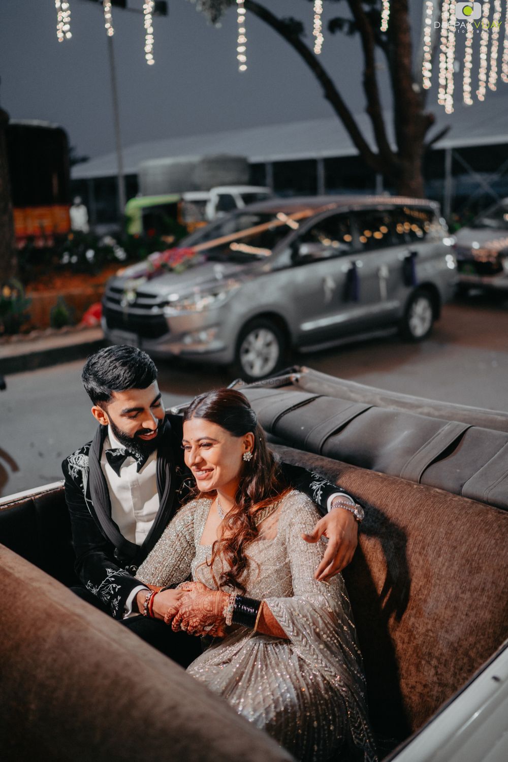 Photo of Bright & happy couple shot in vintage car