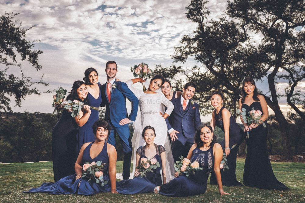 Photo of Couple with matching bridesmaids in blue