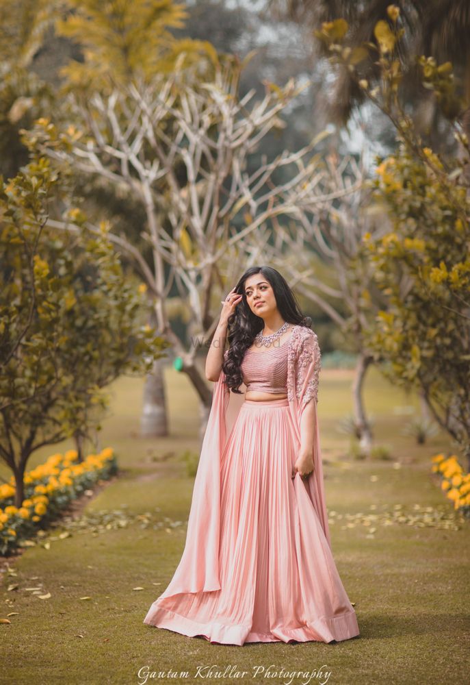 Photo of Light peach engagement lehengas with cape sleeves
