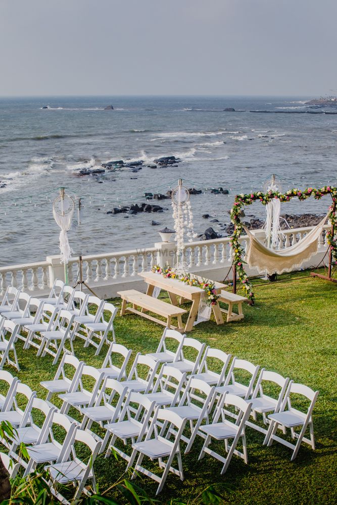 Photo of All white beachside wedding decor seating