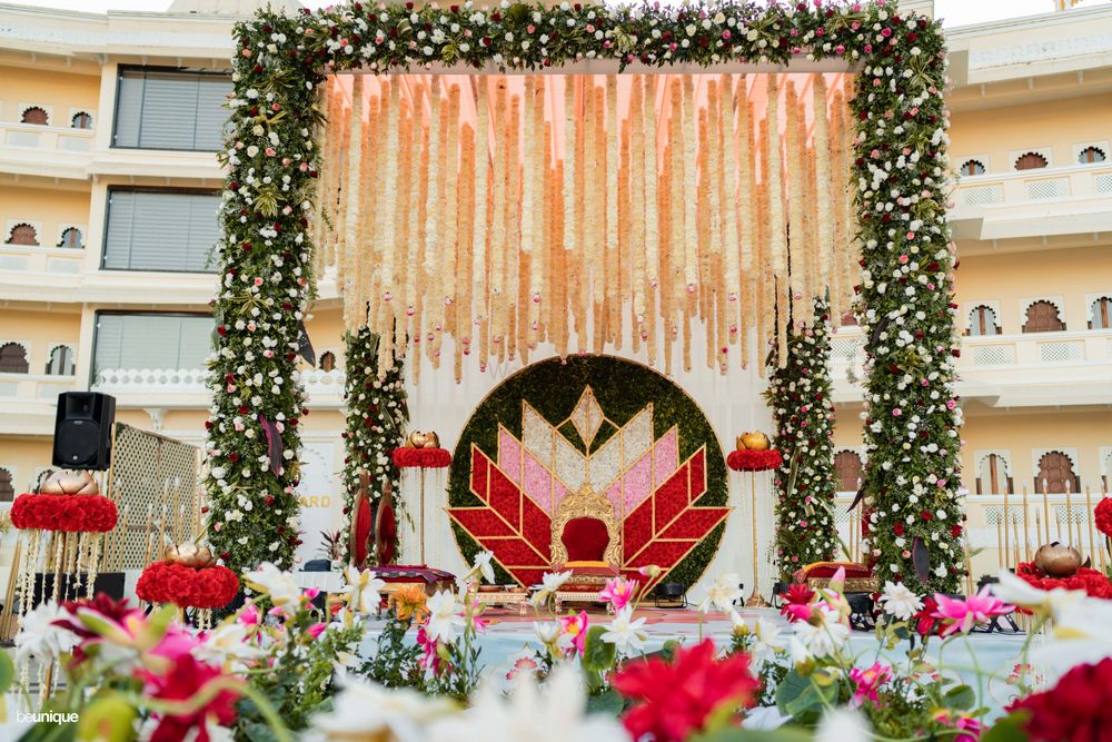 Photo of A beautiful floral mandap with a multicolored-floral backdrop