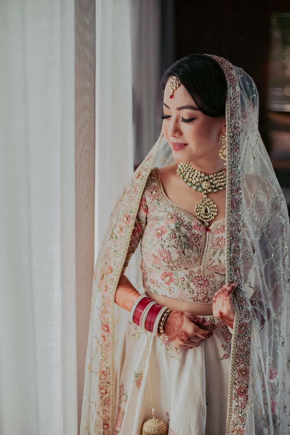 Photo of Bride dressed in an ivory lehenga.