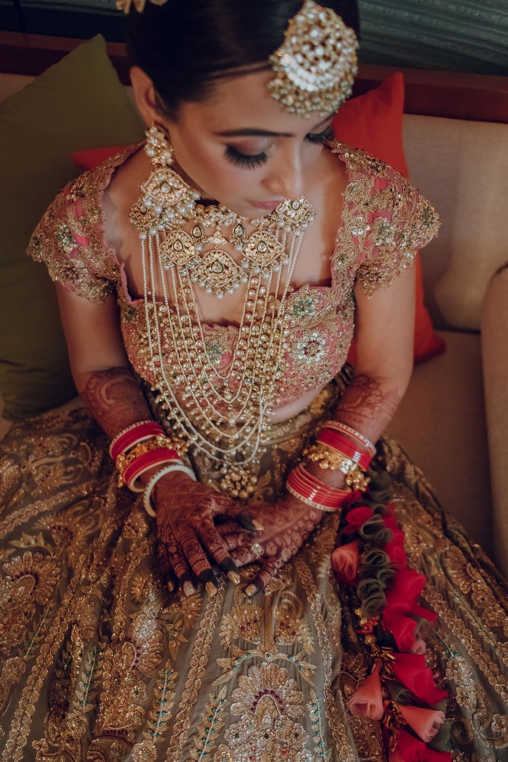 Photo of Brid wearing a choker and a haar with her pastel-hued lehenga.