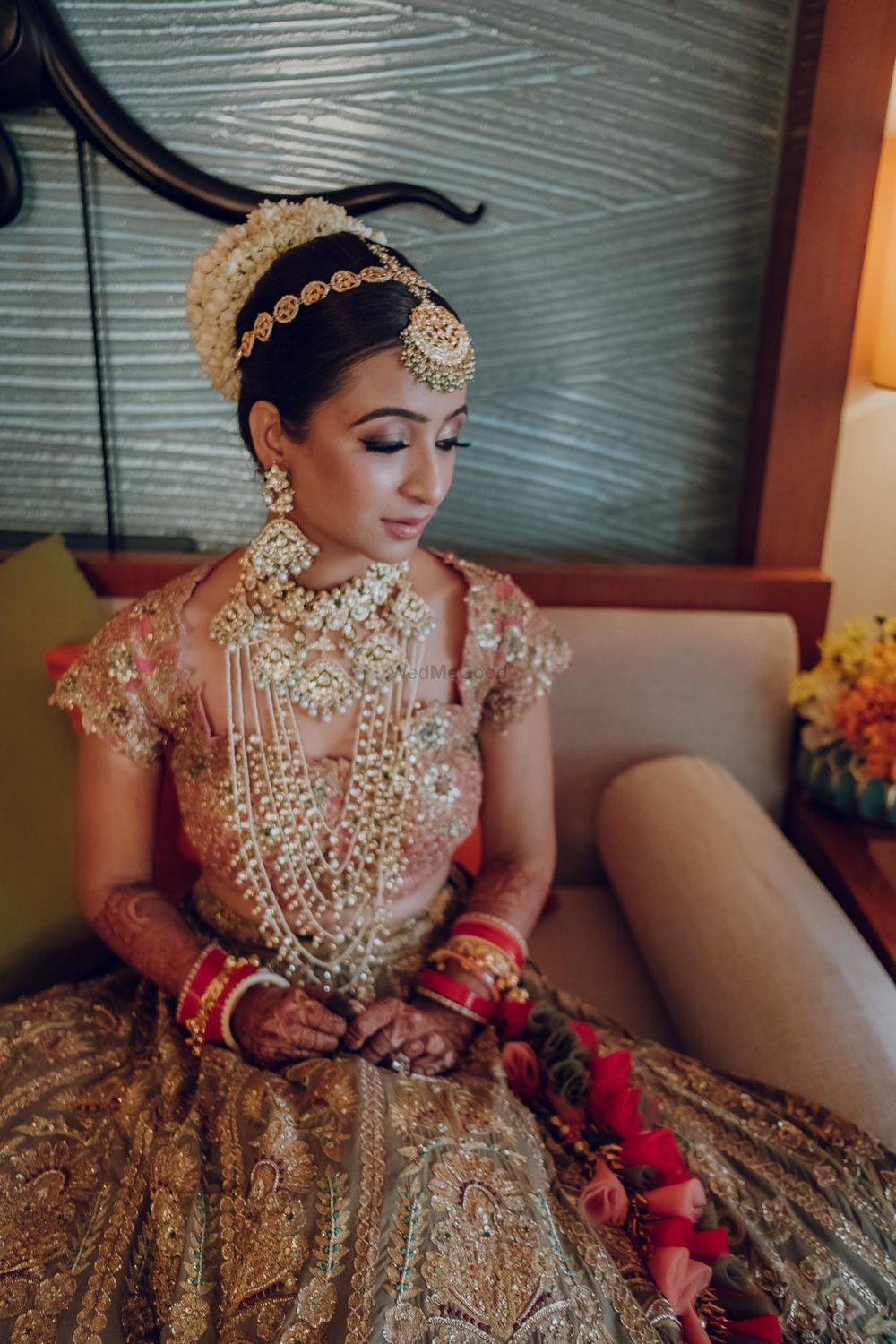 Photo of Bride wearing OTT layered necklaces and a sheeshpatti with lehenga.