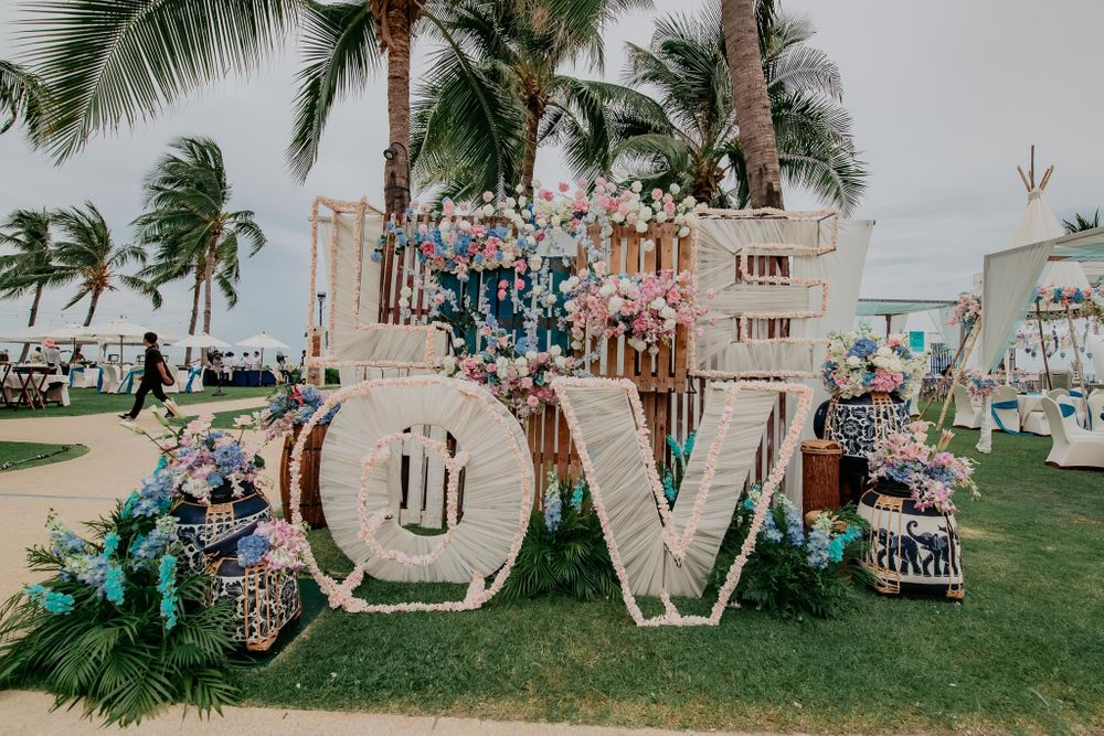Photo of Photo backdrop created with huge monograms, wooden boxes and florals.