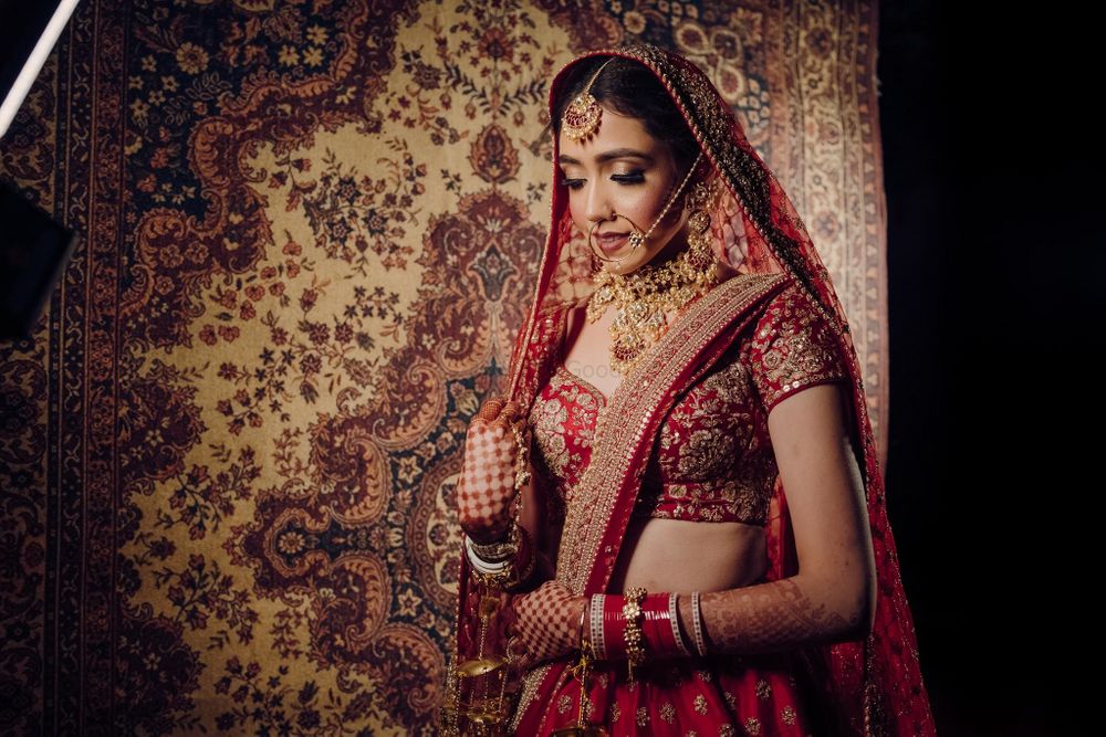 Photo of Bride wearing a red bridal lehenga.