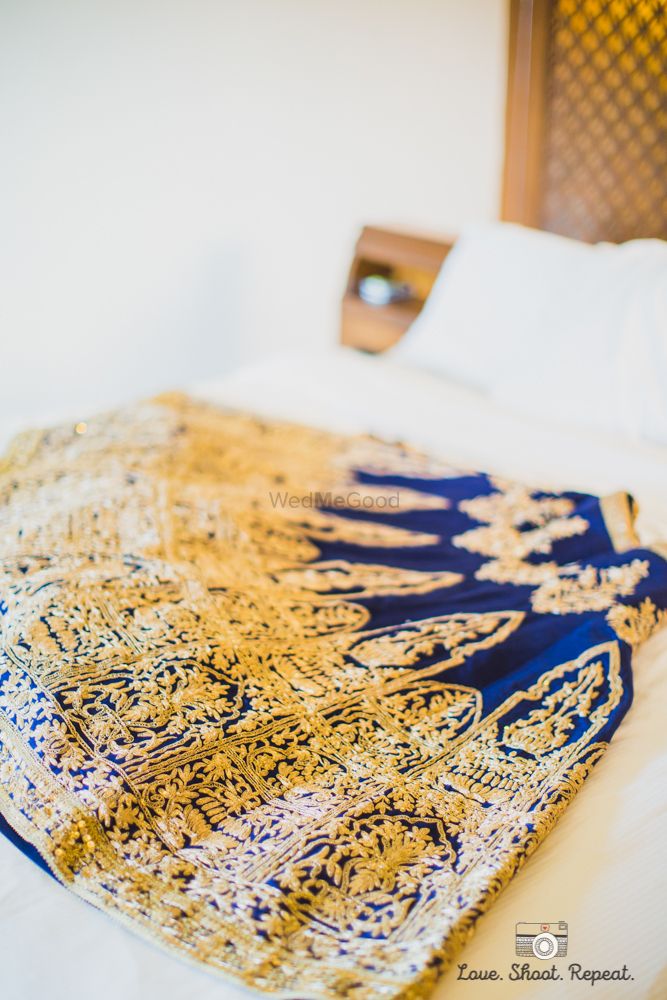 Photo of Blue velvet lehenga with gold royal embroidery
