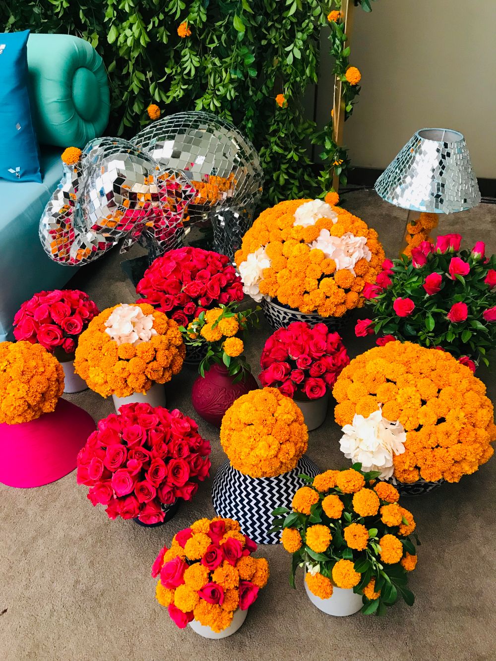 Photo of Vases filled with marigolds and red roses.