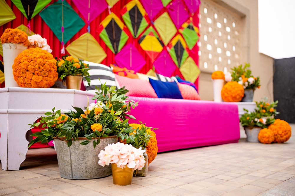 Photo of mehendi decor done with vivid hues and marigolds.