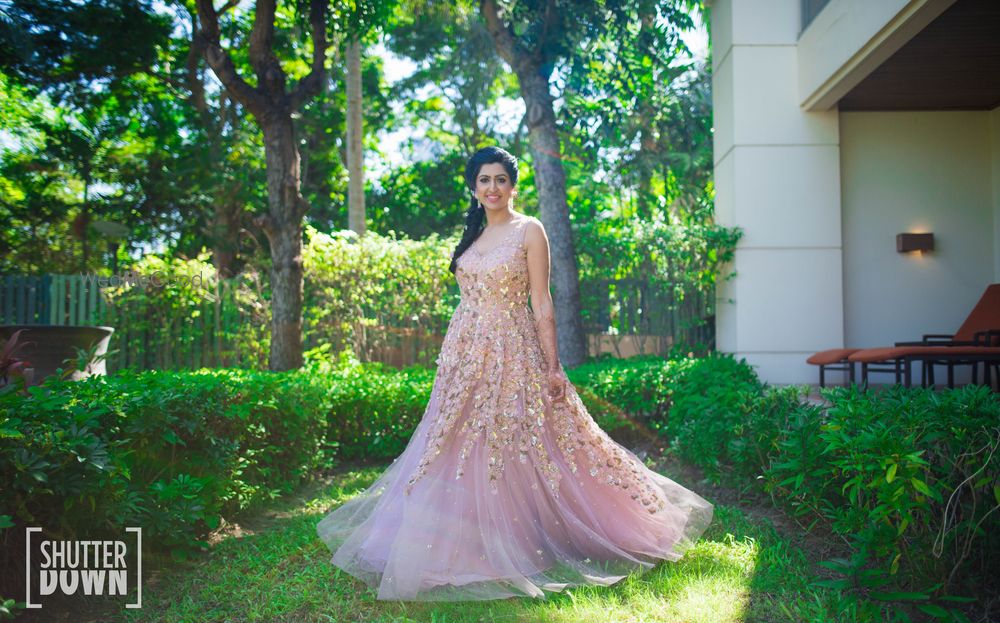 Photo of Light pink sleeveless net gown with flowers all over