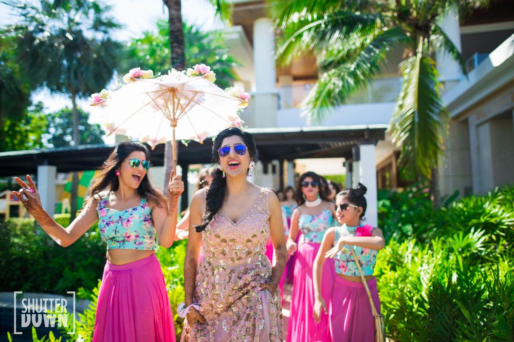 Photo of Dancing entry of bride with bridesmaids holding lace umbrella