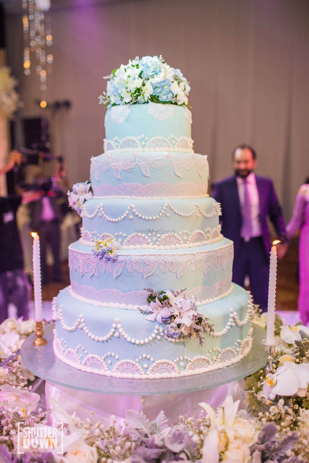 Photo of Giant 5 tier wedding cake with pastel colours and lace design