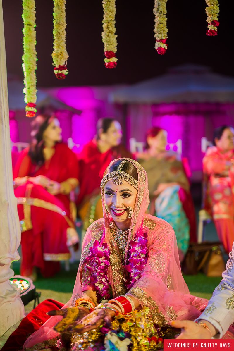 Photo of Happy bride shot wearing light pink lehenga