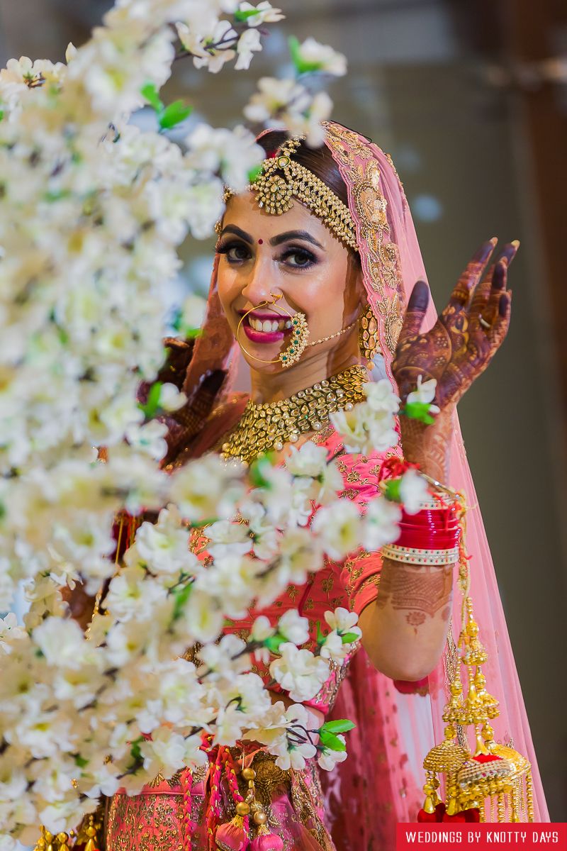 Photo of Happy bride shot against flowers