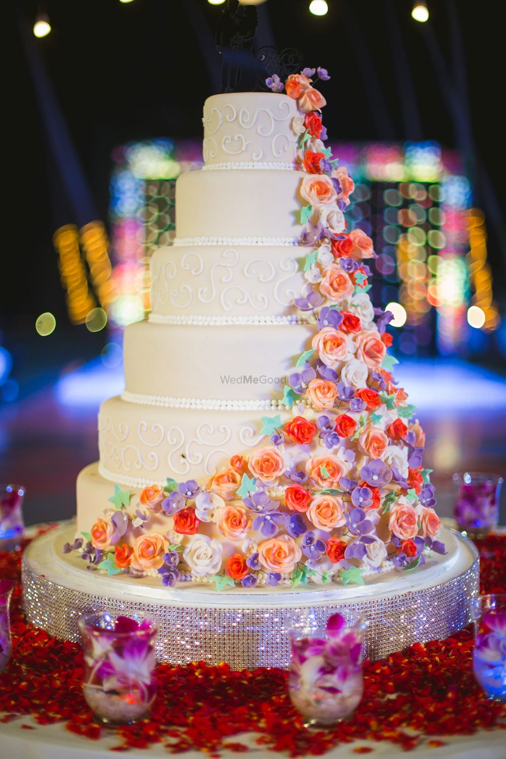 Photo of Colorful cakes on 6 tier white wedding cake