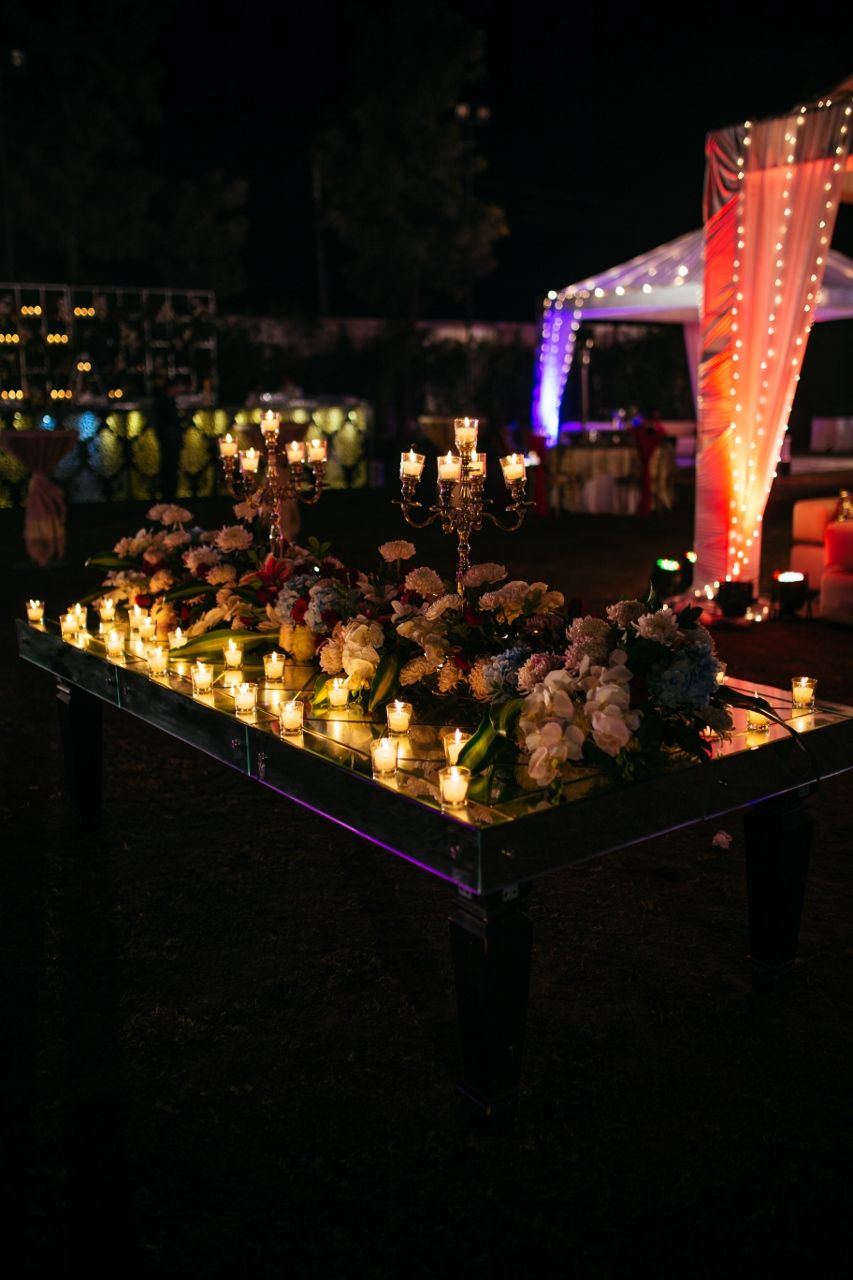 Photo of Candle stands and floral table centerpieces
