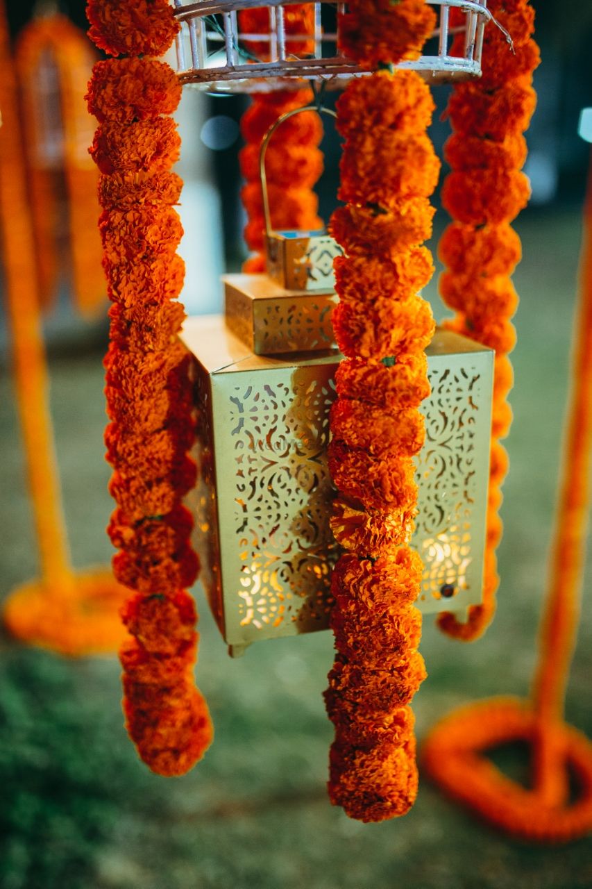 Photo of Hanging candle stands with genda phool strings