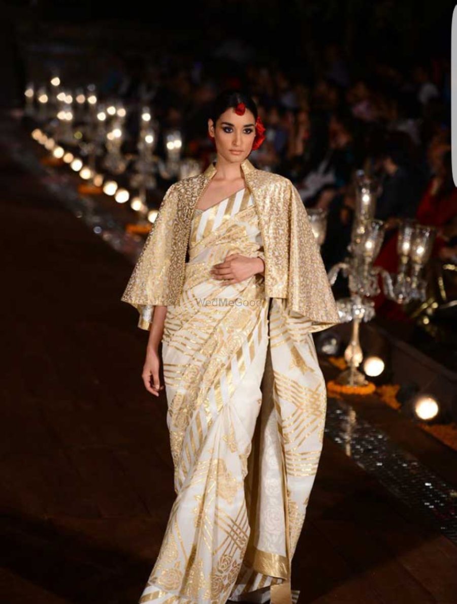 Photo of White and gold saree with cape