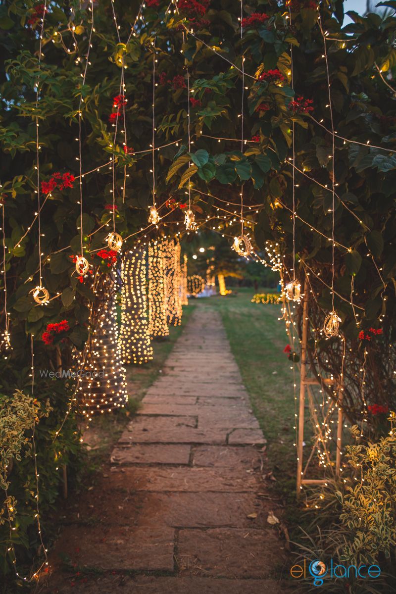 Photo of Minimal fairy lit wedding entrance decor