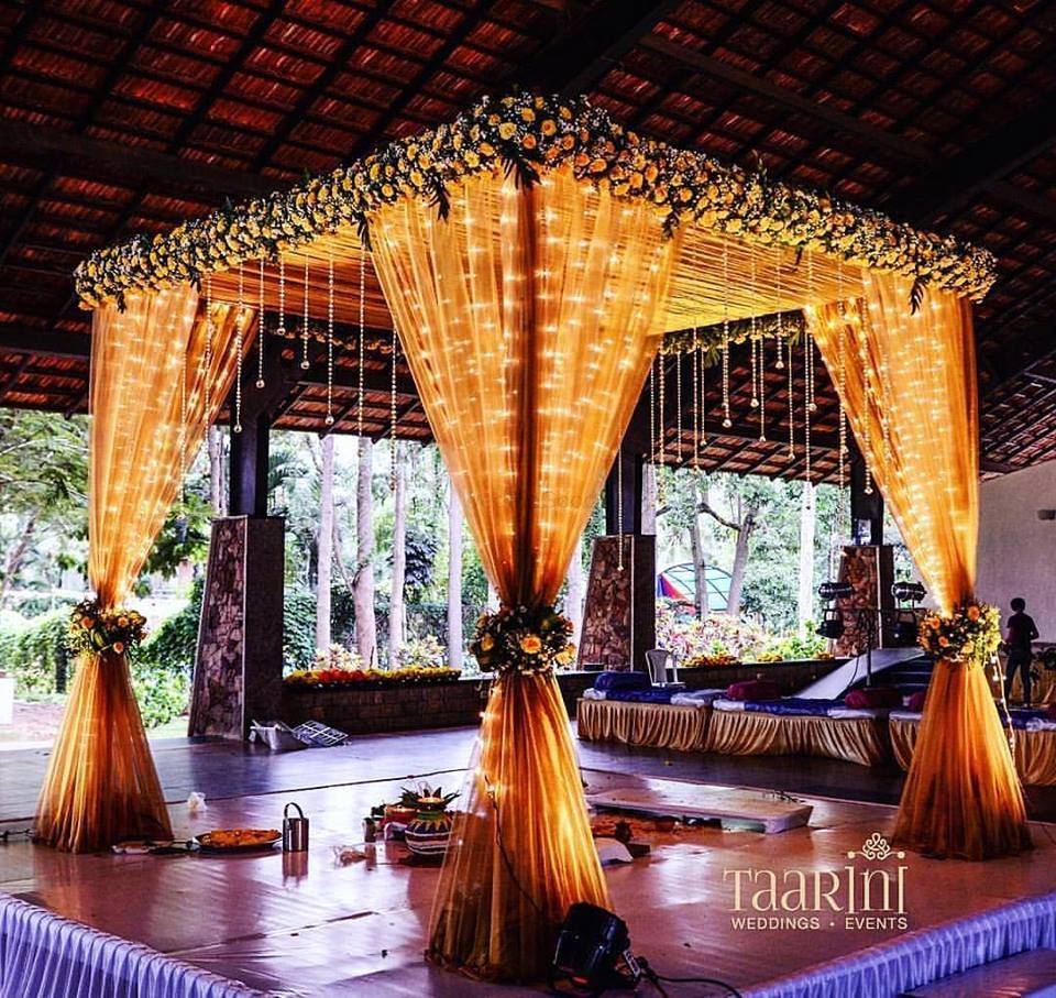 Photo of Mandap with fairy lights and drapes in orange