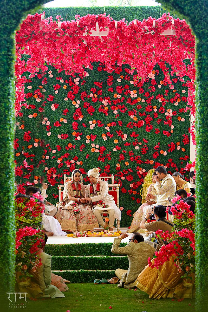 Photo of Floral wall unique mandap in red and green