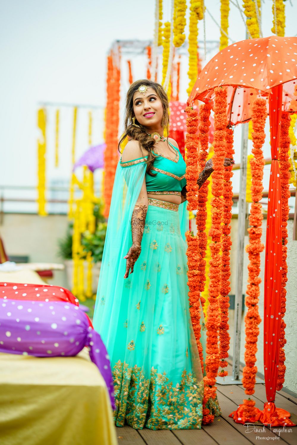 Photo of Lehenga for mehendi with cold shoulder and cape in turquoise