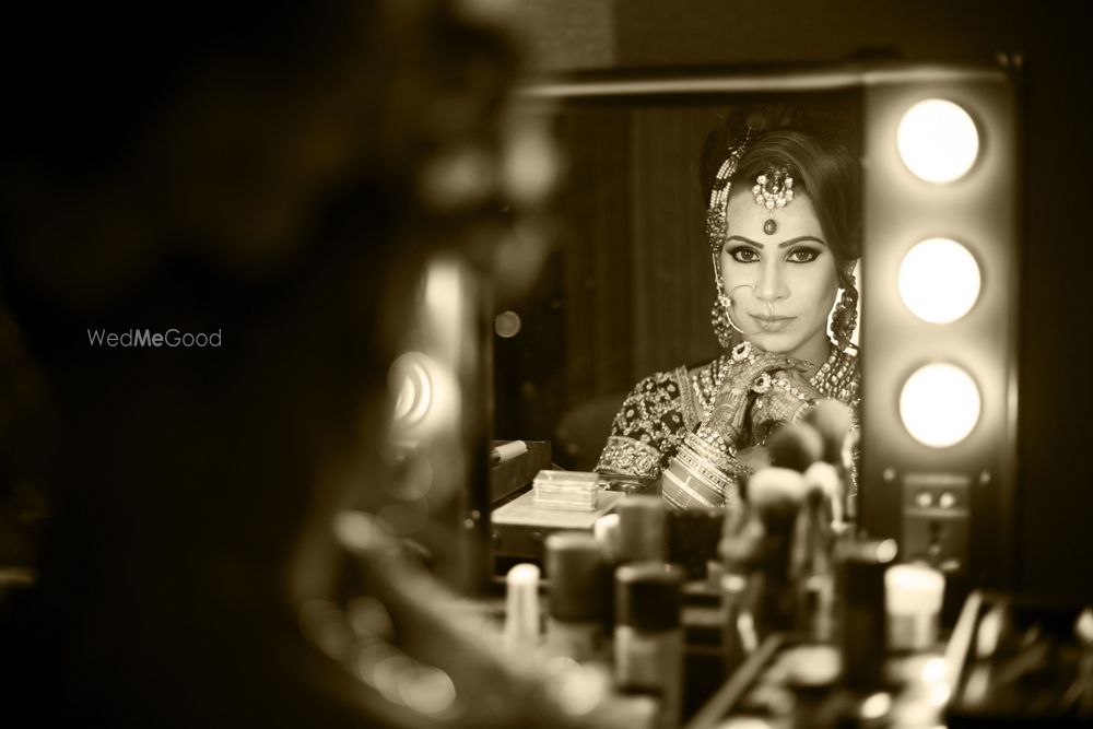 Photo of Bride looking in the mirror shot