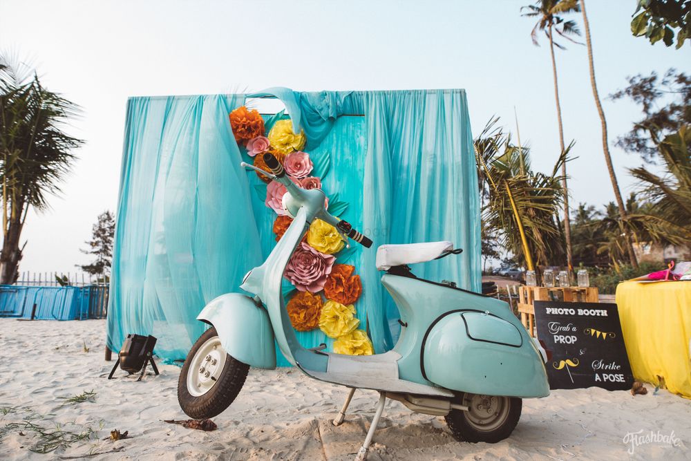 Photo of Photobooth idea for beach wedding with scooter