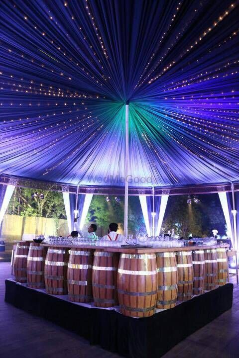 Photo of Bar decor idea with beer barrel props under table