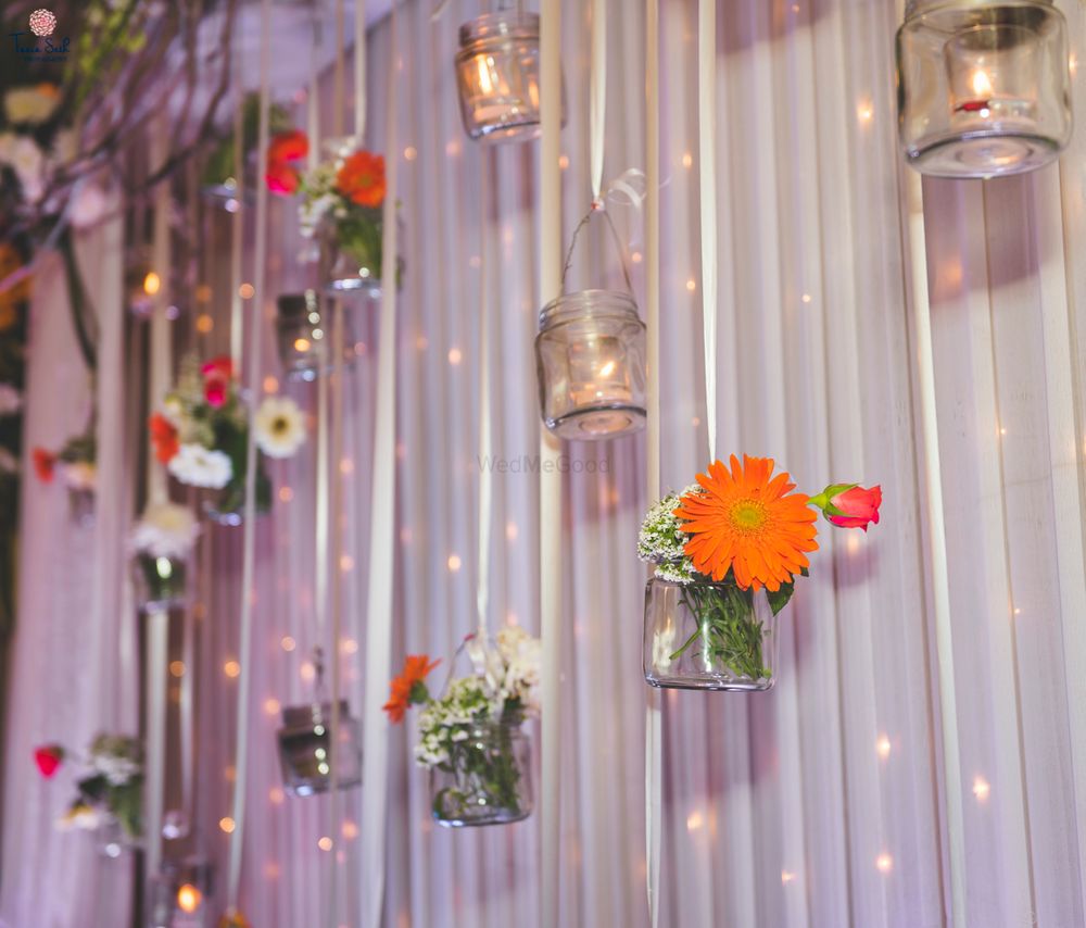 Photo of Hanging jars with flowers and candles