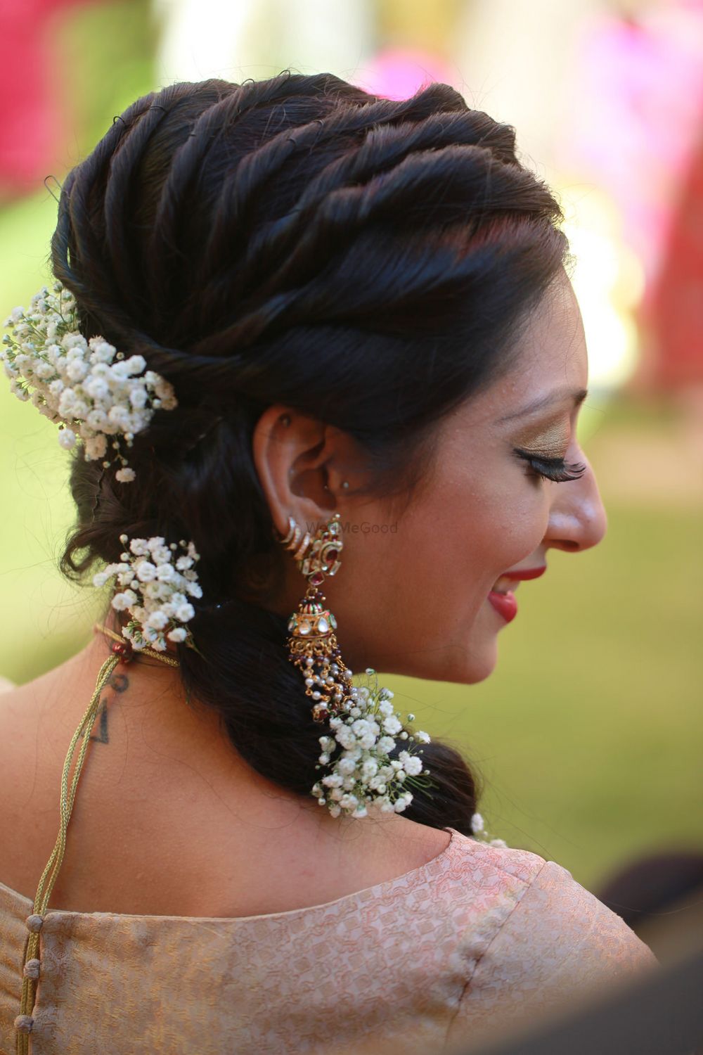 Photo of Twisted hairstyle for mehendi with babys breath