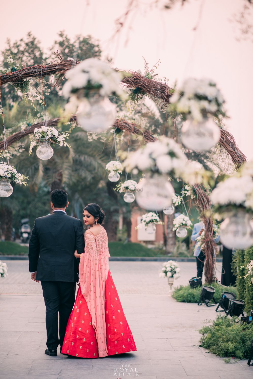 Photo of Light pink and red lehenga with cape