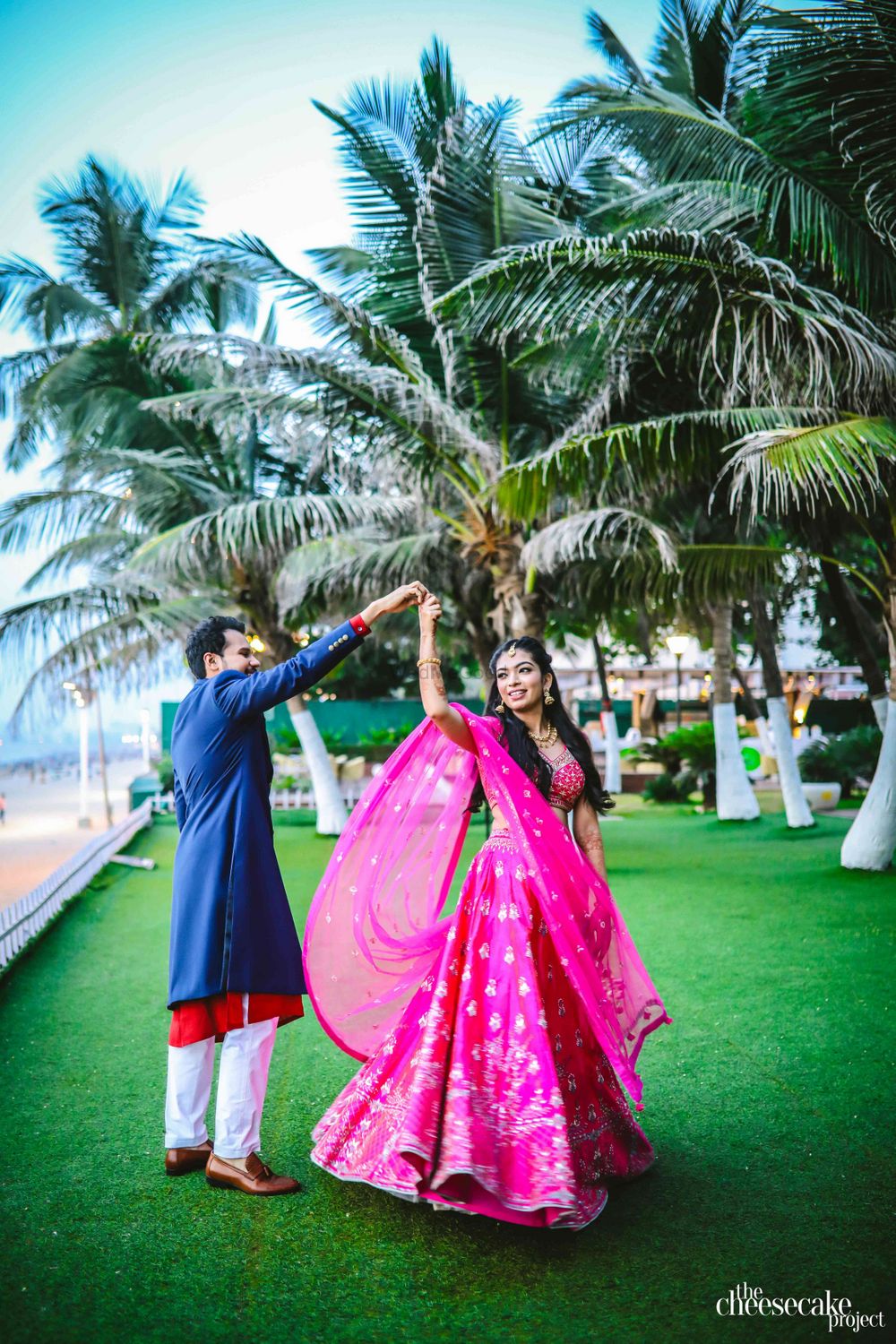 Photo of Bright pink engagement lehenga with twirling bride
