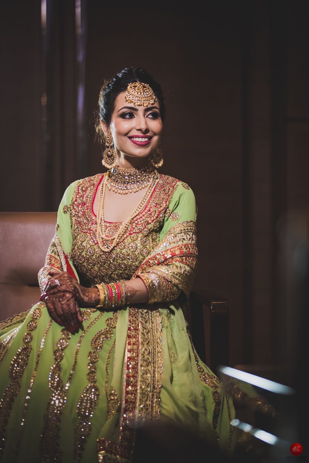 Photo of Gold engagement jewellery with layered necklaces and maangtikka