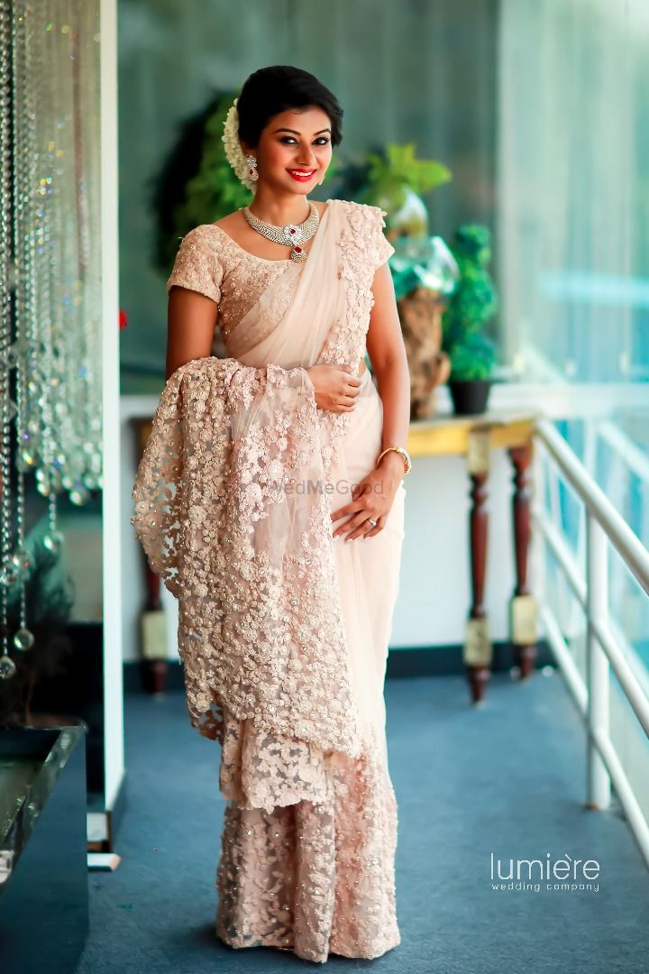 Photo of White lace saree with train for south indian bride