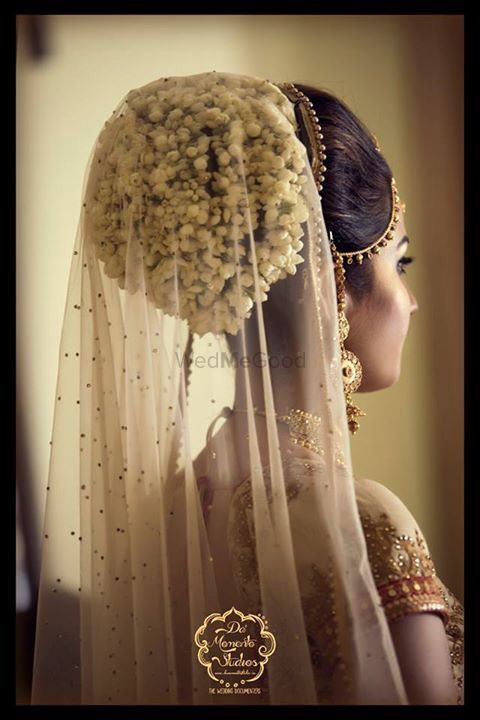 Photo of Bridal bun with flowers and attached dupatta