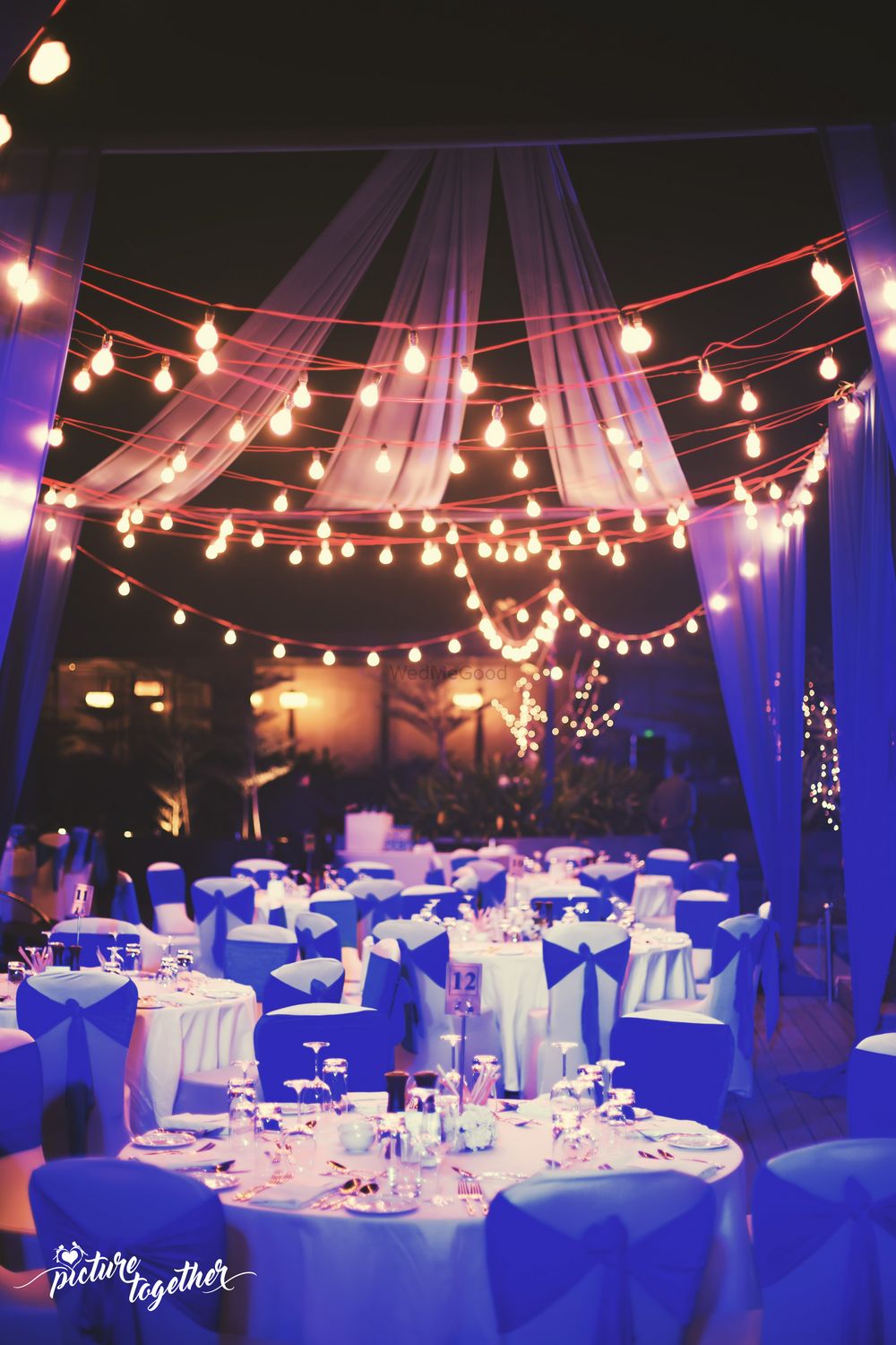 Photo of Intimate dinner setting with hanging bulbs