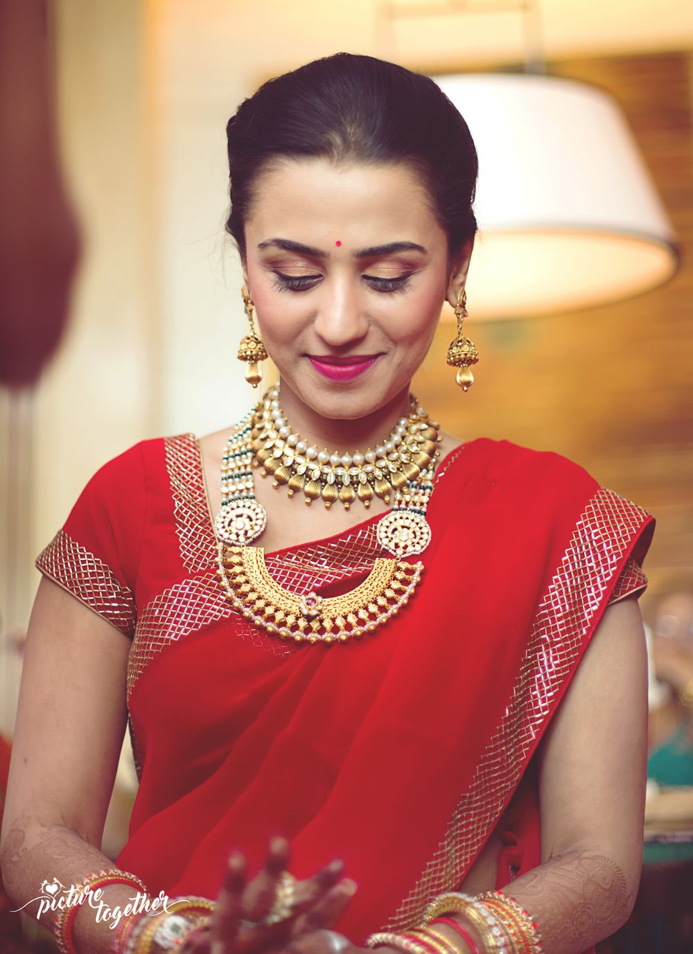 Photo of Bride in red saree and layered necklaces